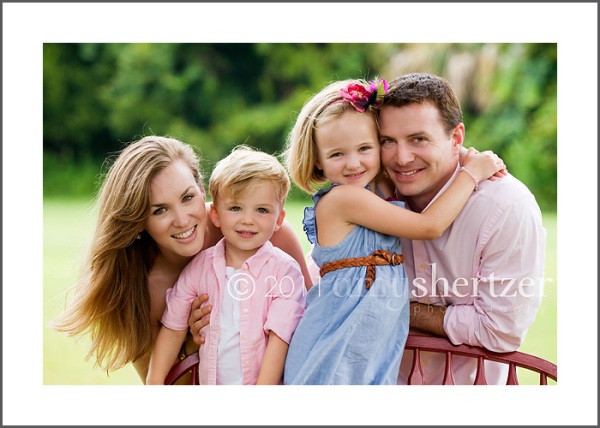 A family of 4 poses for a photo shoot for a Los Angeles-based family portrait photographer.